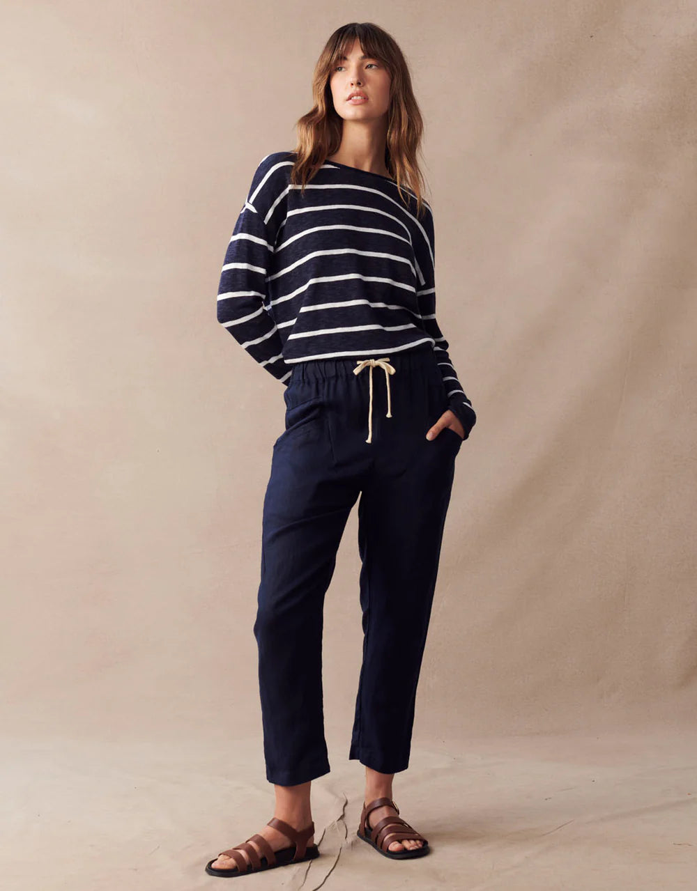 Model wearing Little Lies Luxe Linen Pants in navy with striped top