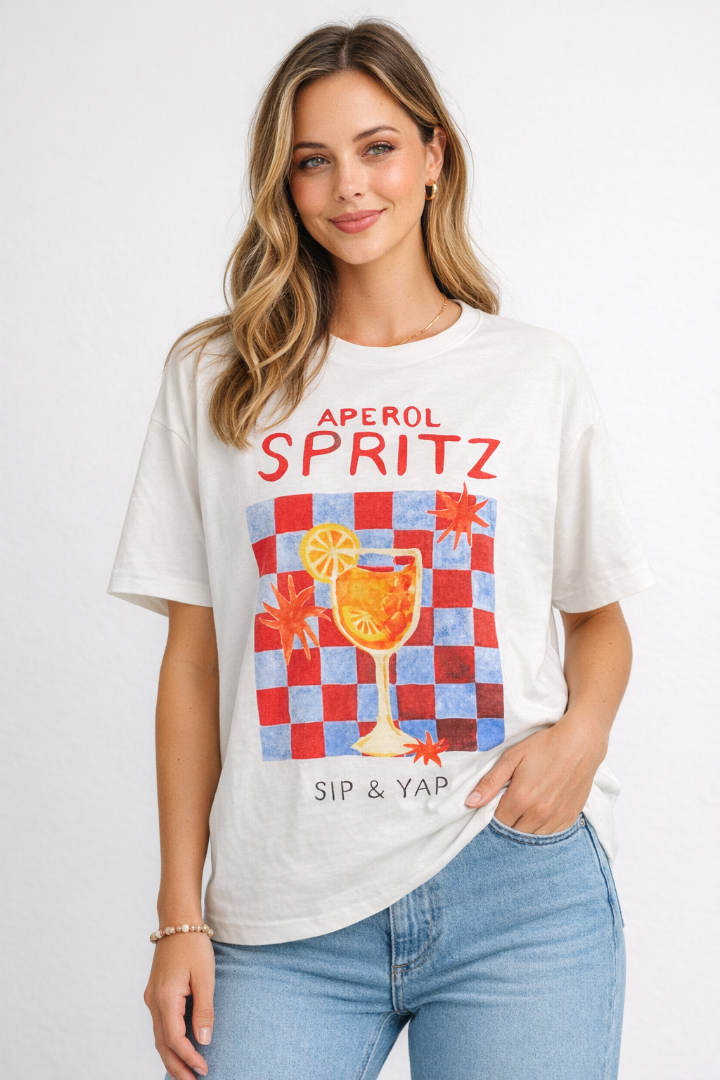 Woman wearing a white t-shirt with 'Aperol Spritz' graphic design on a plain background