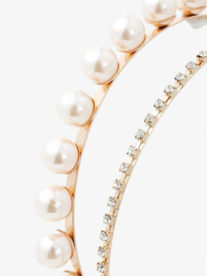 Two gold bracelets, one with pearls and the other with diamonds, on a white background.