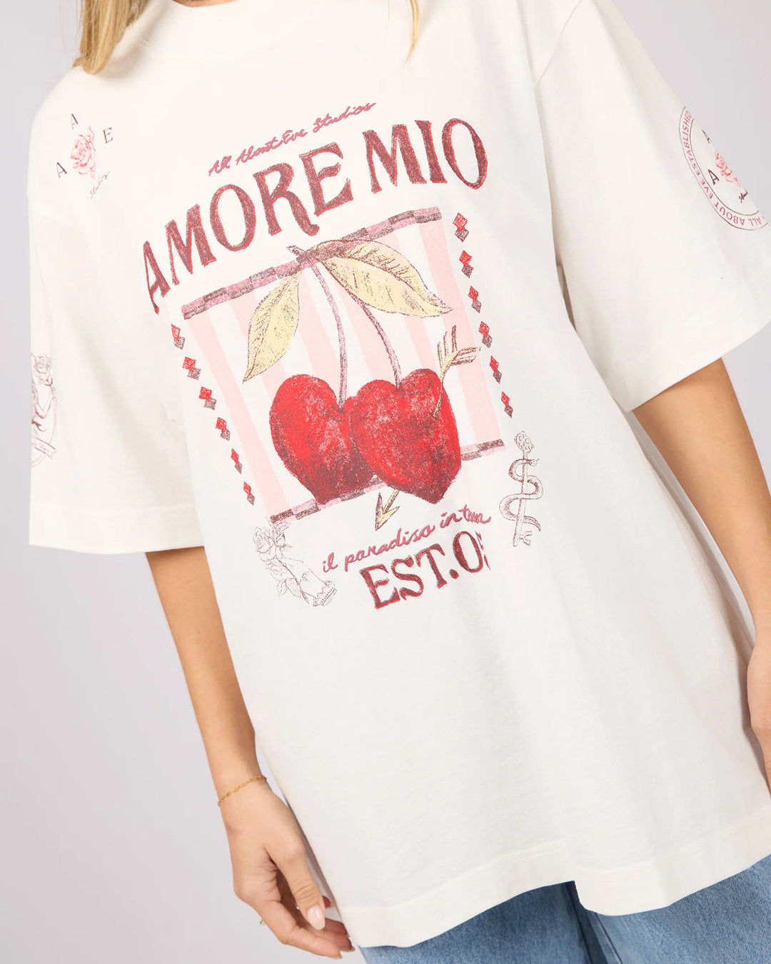 White t-shirt with red cherries and text design on a gray background