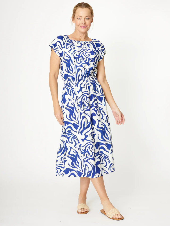Woman wearing a blue and white patterned dress on a white background