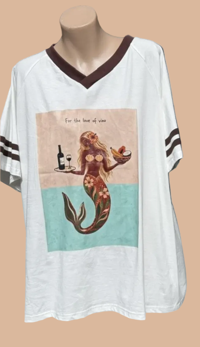 White oversized V-neck t-shirt displayed on a mannequin torso, featuring dark brown trim, sleeve stripes, and a central graphic of a mermaid holding a wine glass and bottle on a beige and teal background.