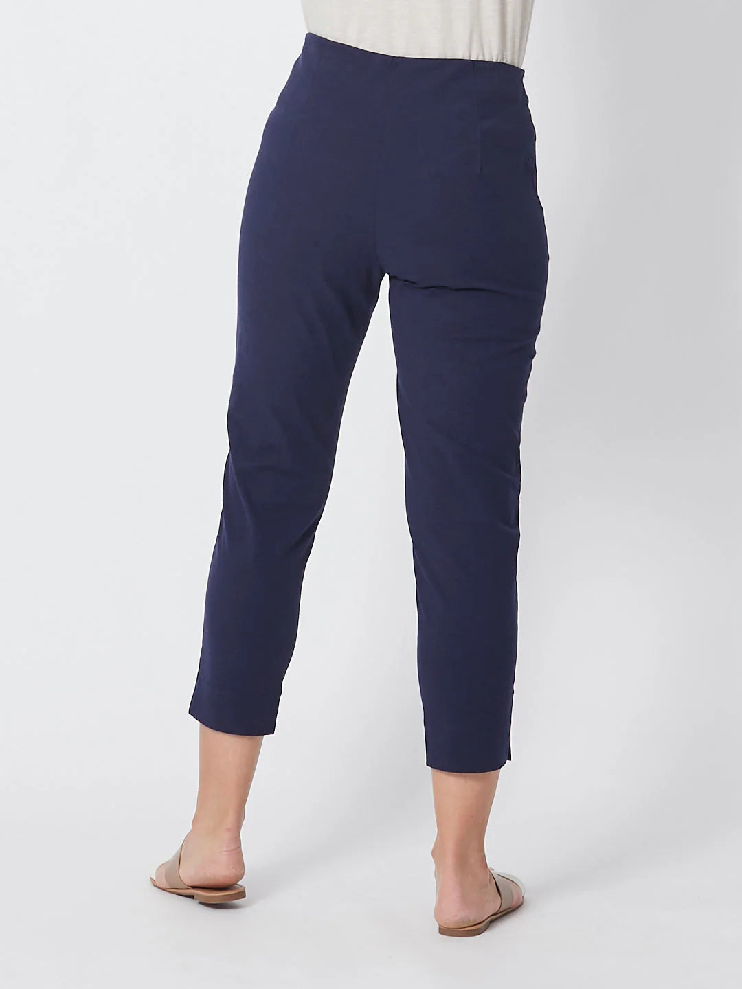Navy blue pants worn by a person on a white background