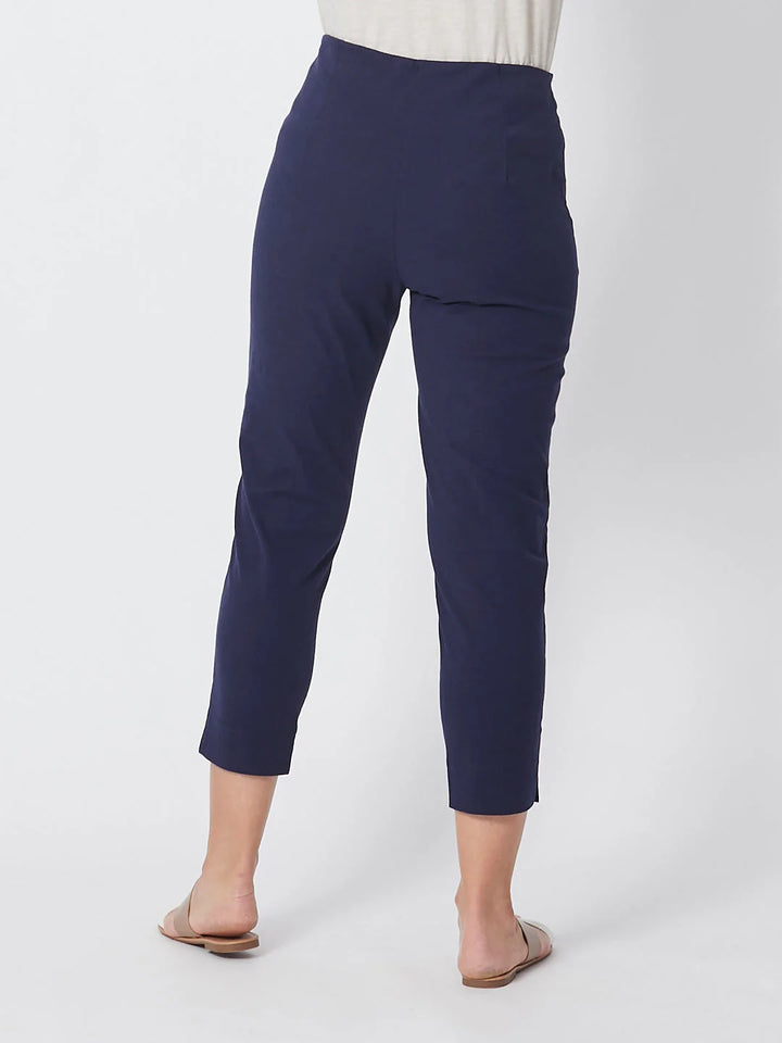 Navy blue pants worn by a person on a white background
