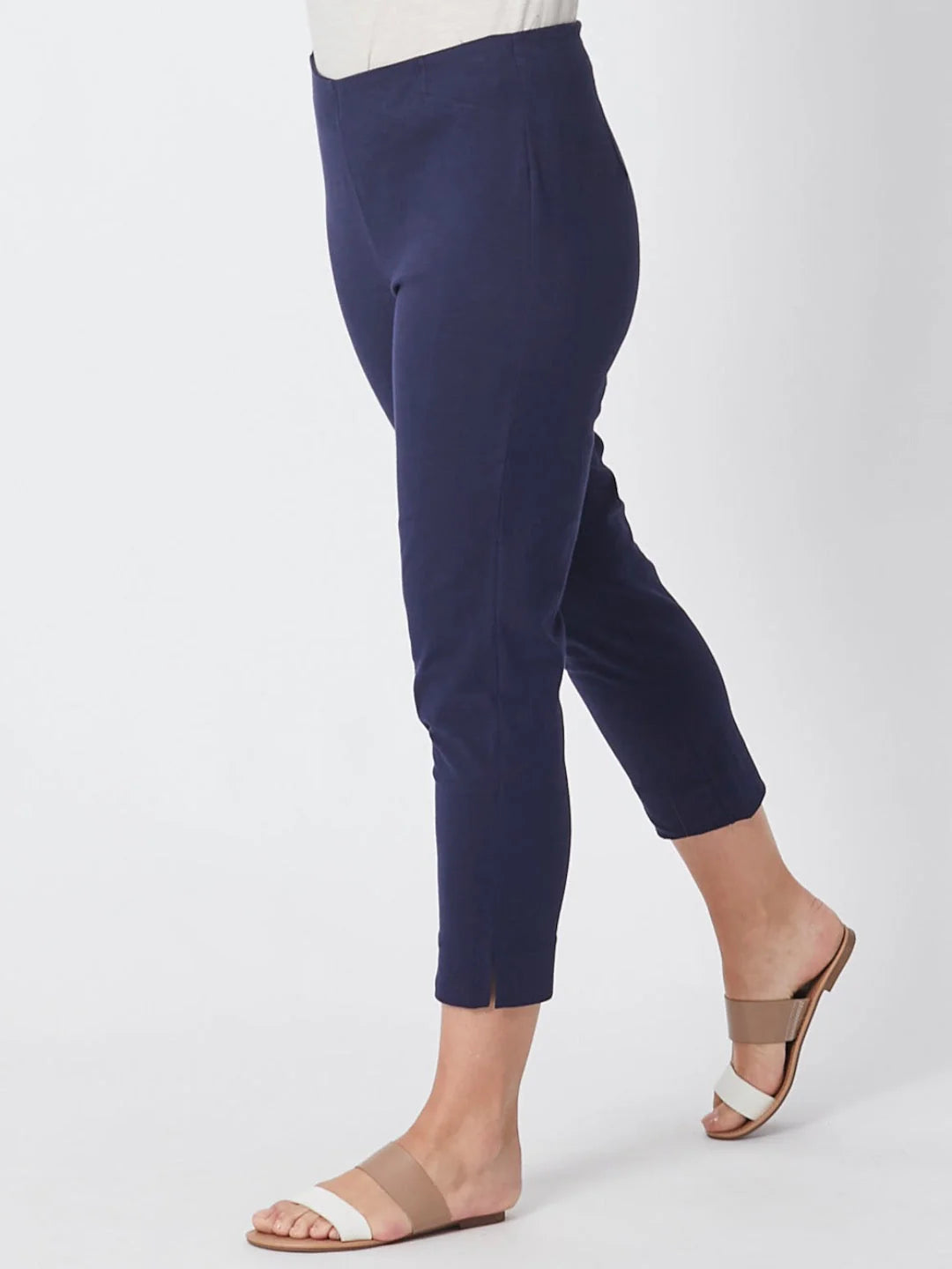 Navy blue pants worn by a person on a white background