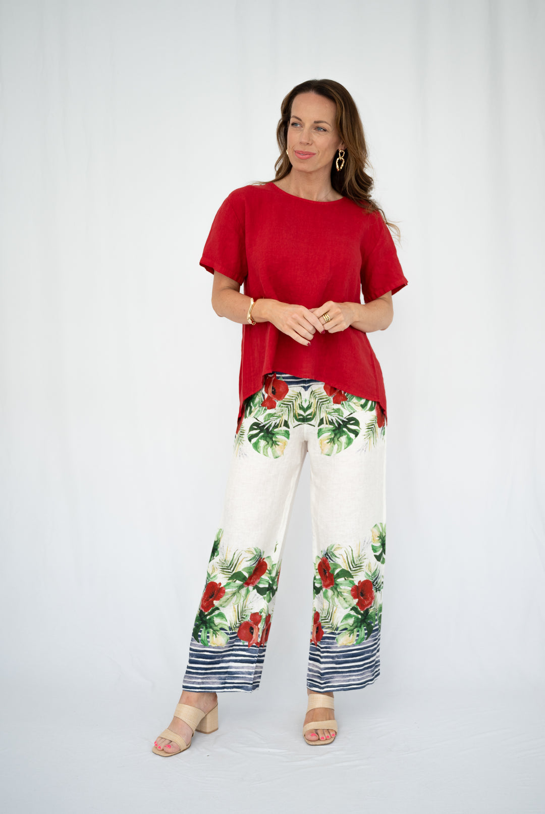 Woman wearing a red top and floral pants on a white background
• Capri Coast Linen Pants
• Italian linen wide leg pants
• botanical print linen pants
• tropical floral linen trousers
• summer linen outfit Australia
• lightweight linen pants for Queensland
• coastal resort wear Sunshine Coast
• white linen pants with floral border