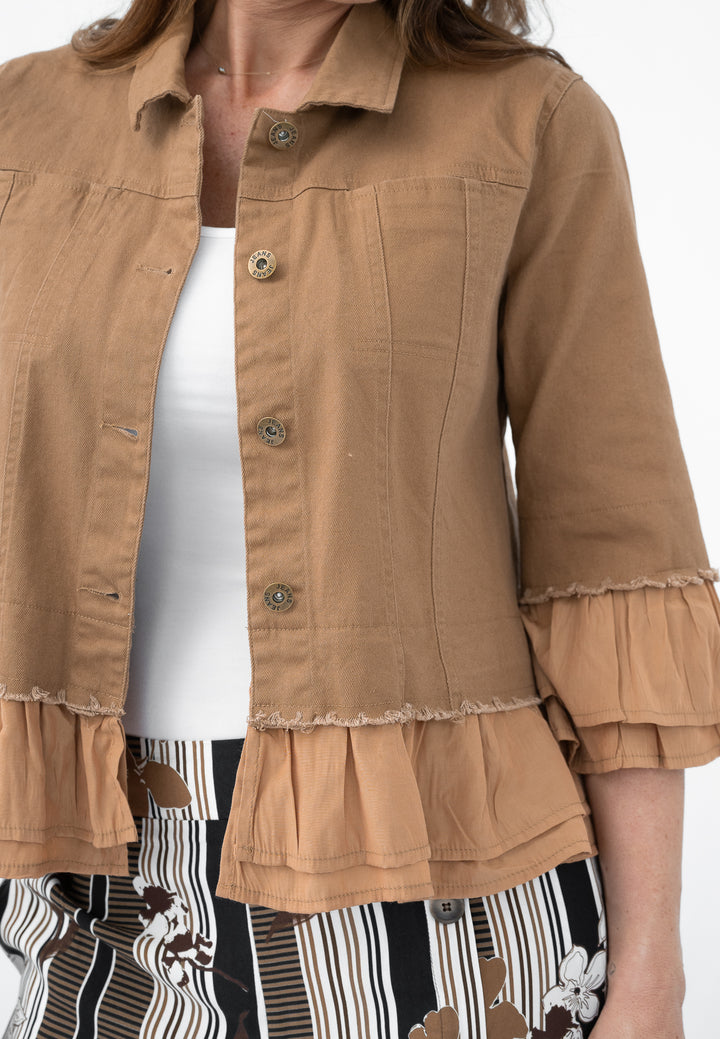 Close-up of a person wearing a brown jacket with ruffled layers on a white background