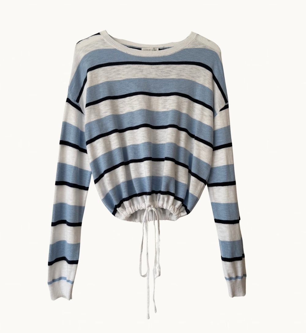 A long-sleeve knit sweater with horizontal stripes in light blue, white, and black, featuring a drawstring hem.
