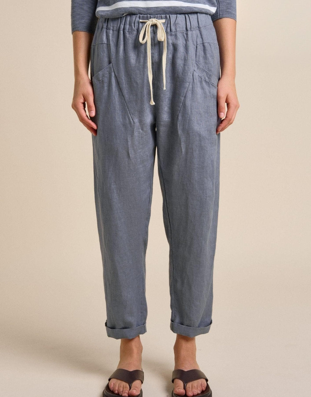Blue pants with a drawstring on a beige background