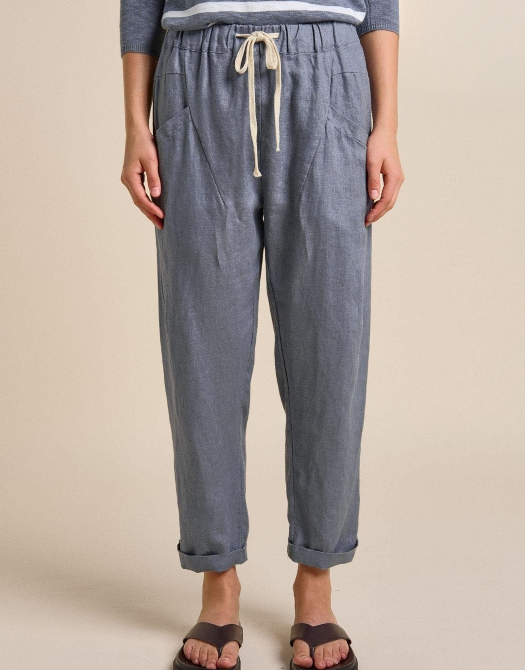 Blue pants with a drawstring on a beige background