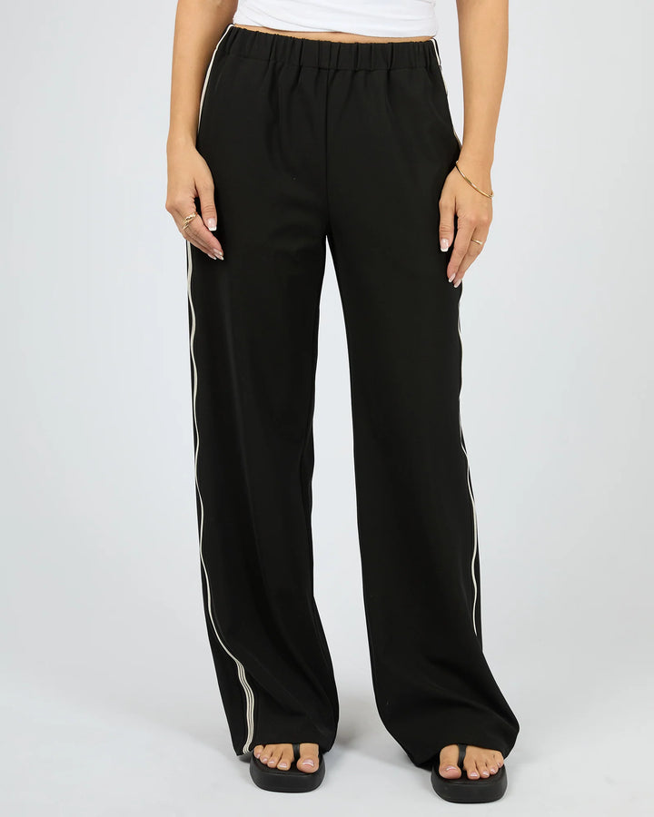 Black wide-leg pants with white stripes on a plain background