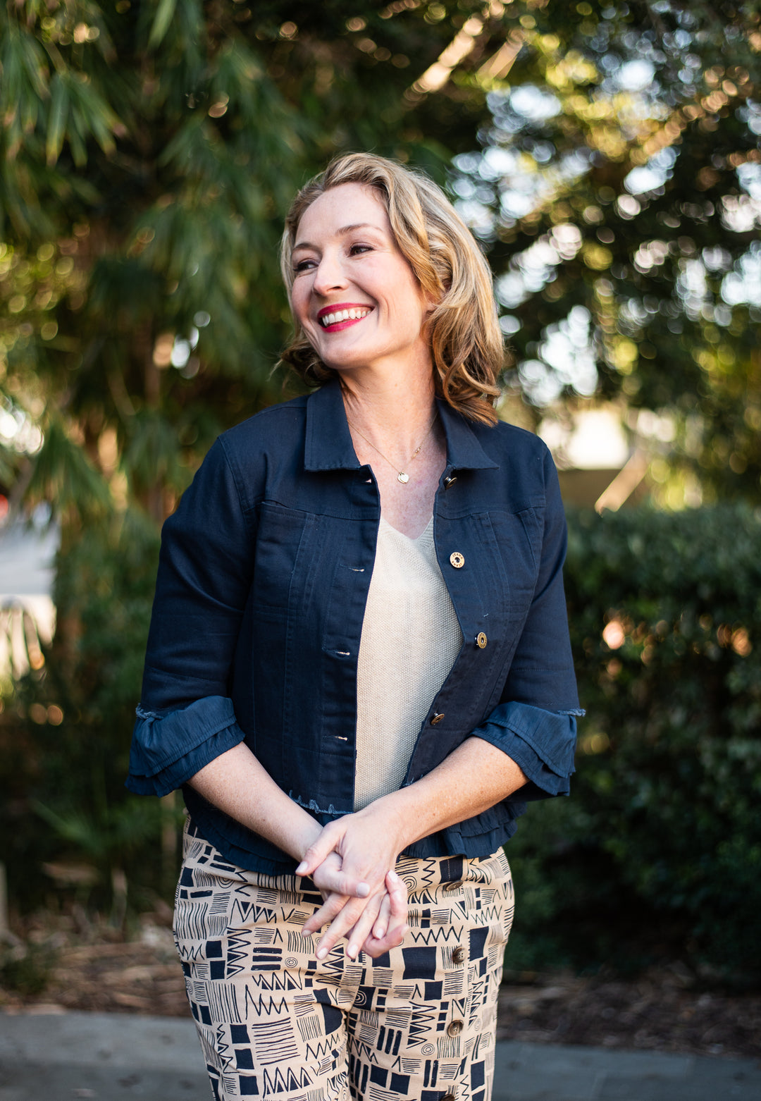 Womens navy stretch jacket styled open over neutral top