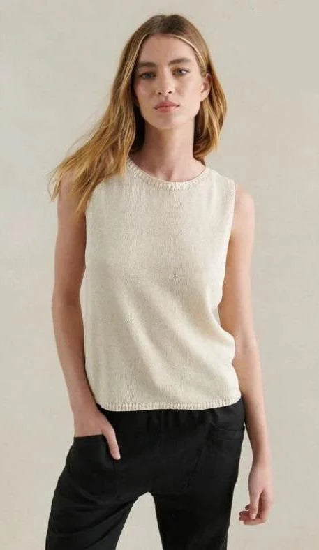 Woman wearing a cream sleeveless top linen cotton blend 