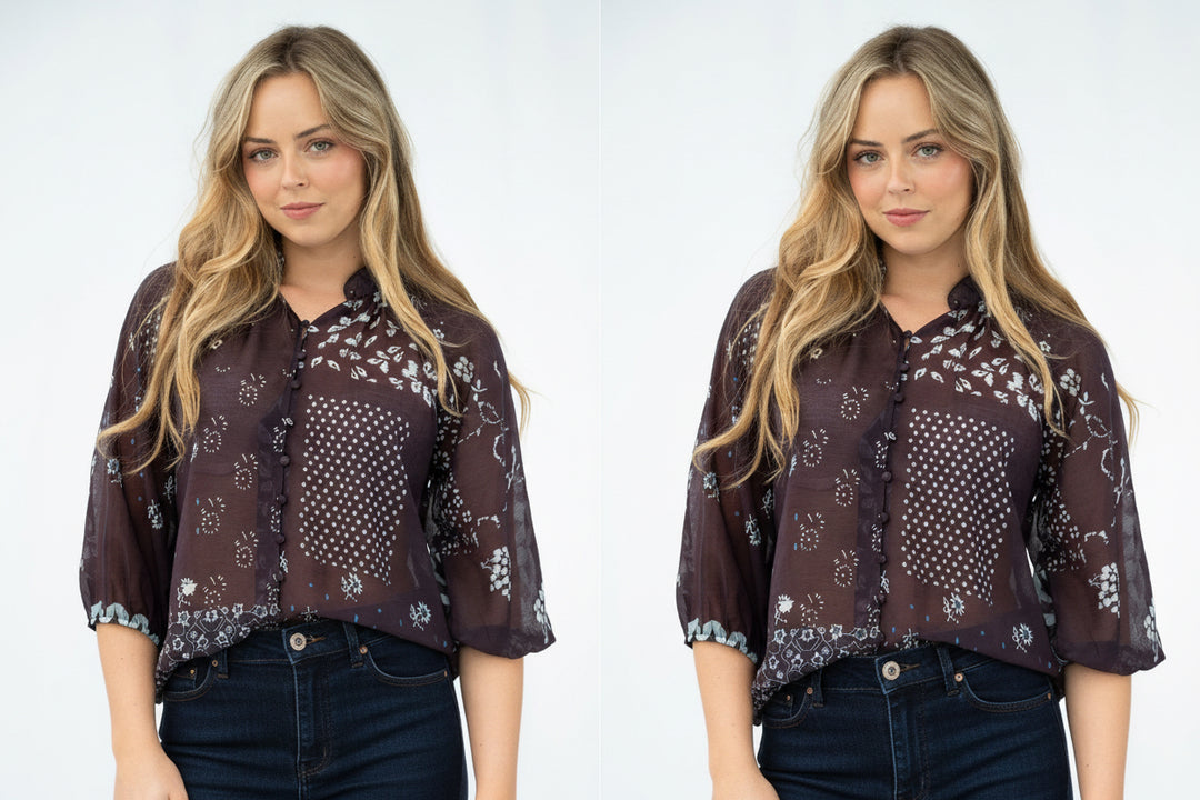 A woman modeling a sheer dark brown button-up blouse with white and blue floral patchwork patterns, paired with light blue jeans, against a plain white studio background.