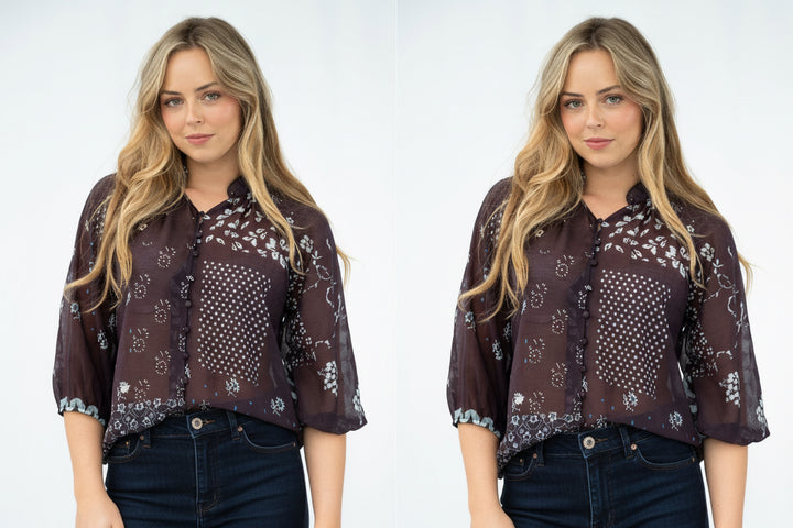 A woman modeling a sheer dark brown button-up blouse with white and blue floral patchwork patterns, paired with light blue jeans, against a plain white studio background.