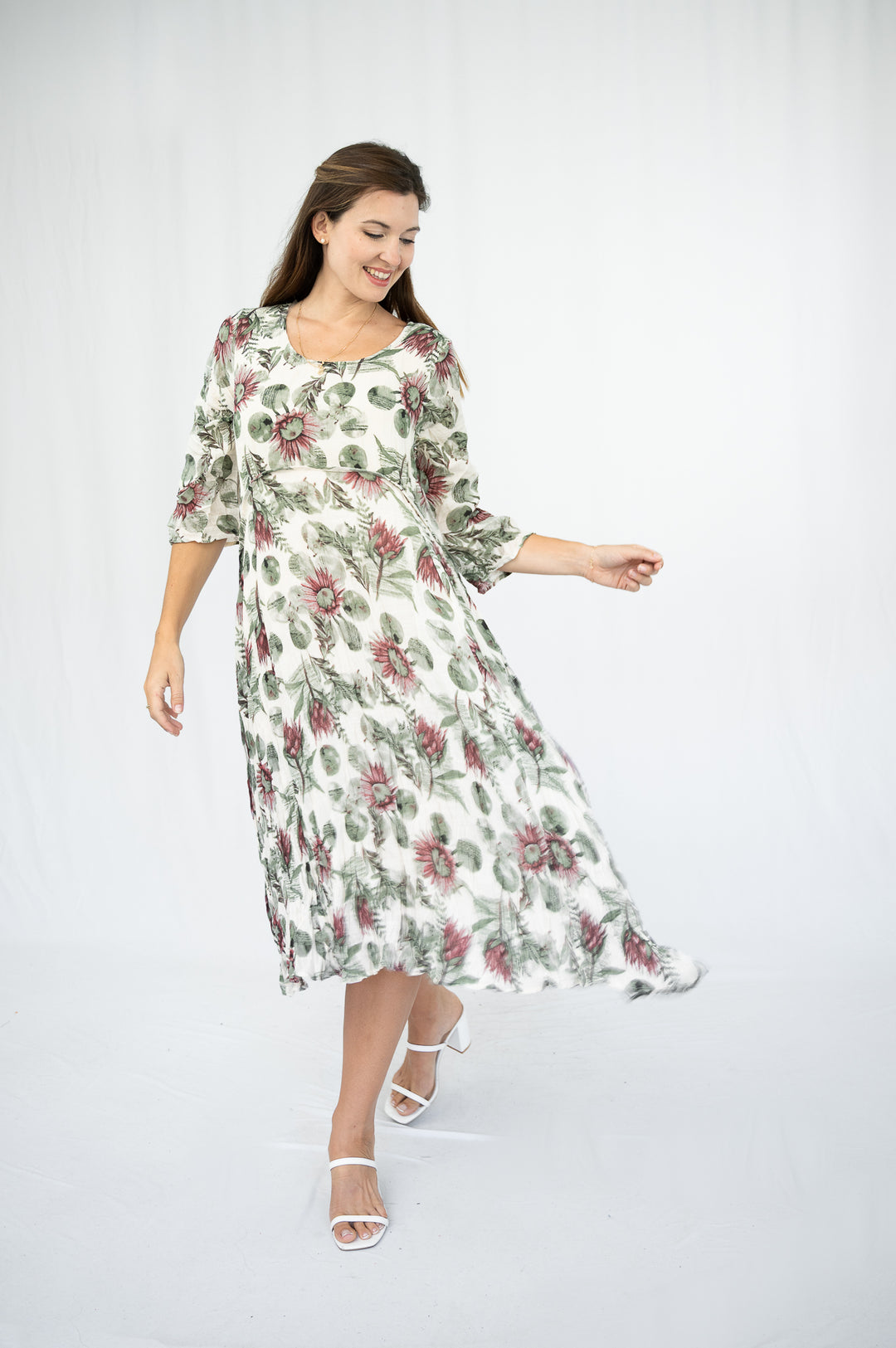 Woman wearing a floral dress on a white background