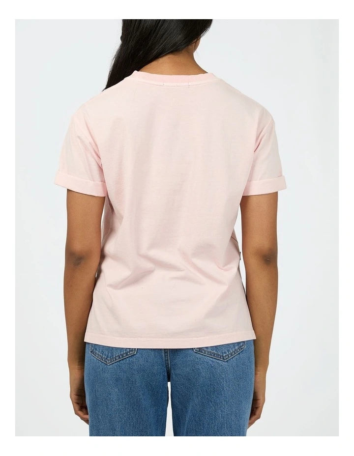 Person wearing a light pink t-shirt and blue jeans on a white background