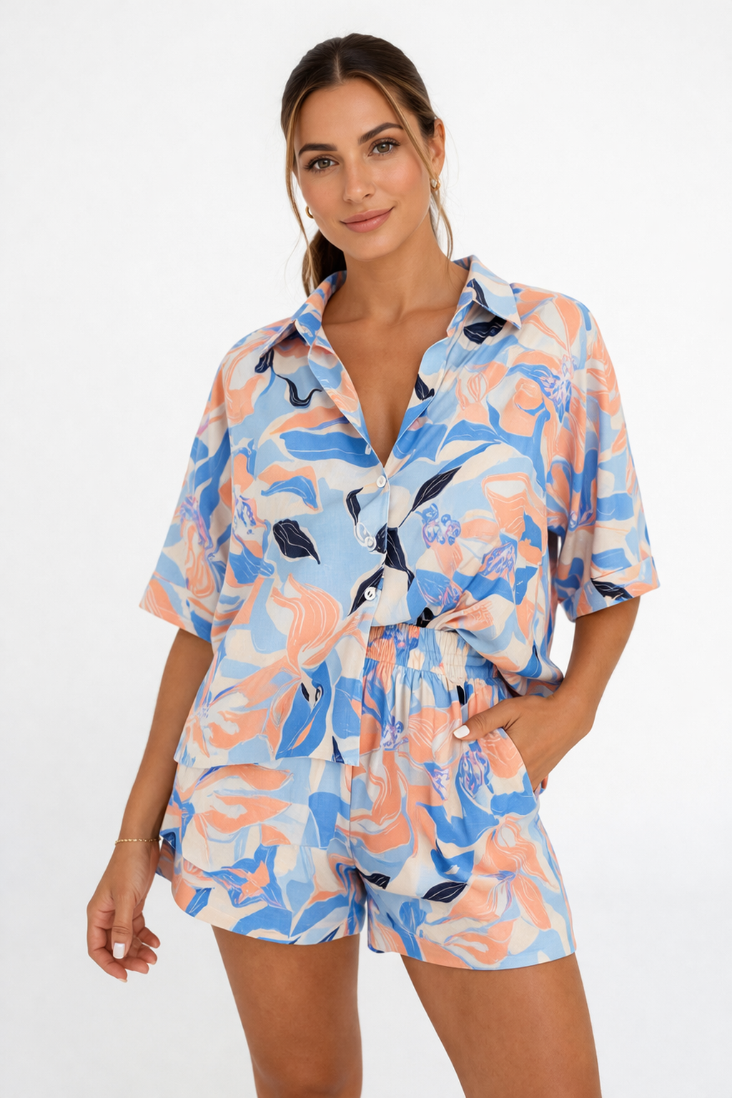Woman wearing a colorful floral romper on a white background