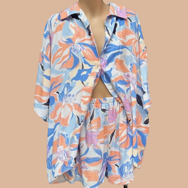 Floral patterned shirt and shorts set on a mannequin in an indoor setting.