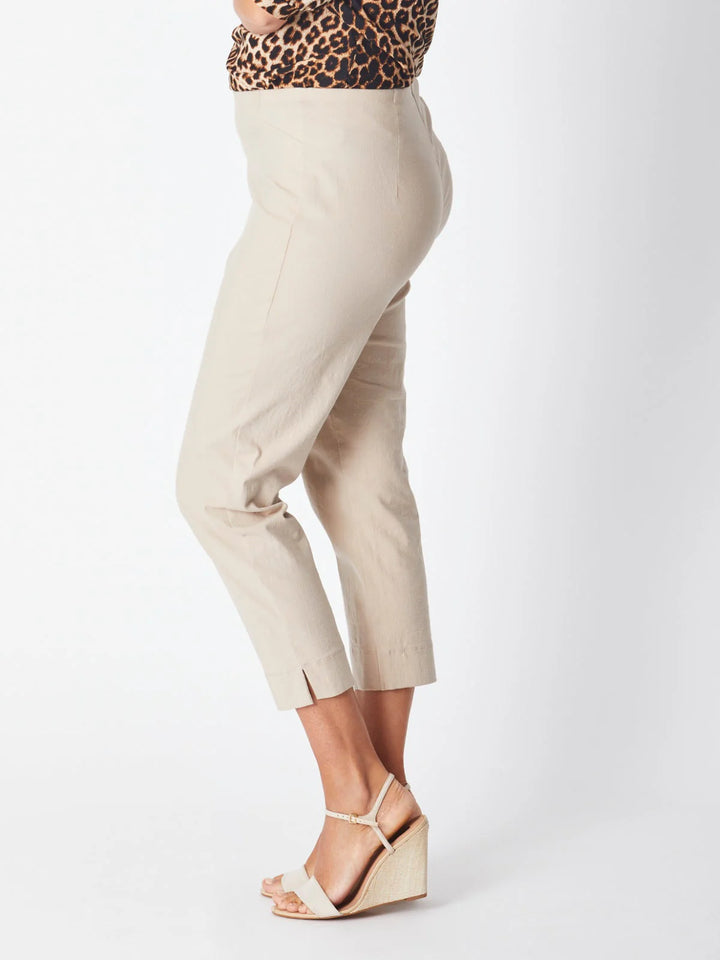 Beige pants worn by a person on a white background