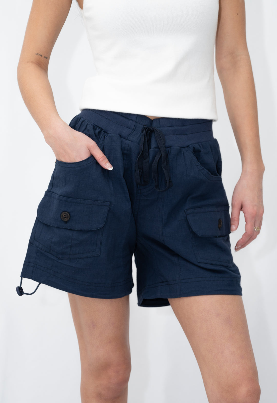 Navy blue cargo shorts worn by a person on a white background
