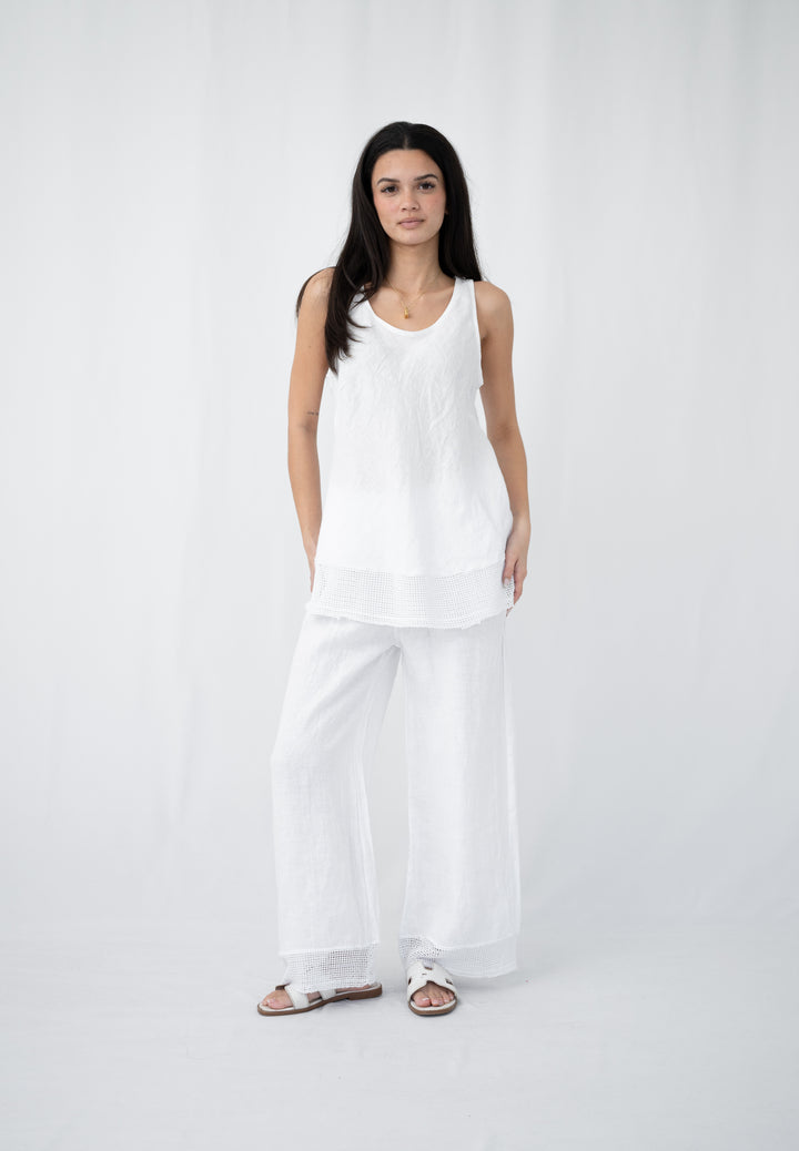 Woman wearing white linen tank top with crochet hem
White linen sleeveless tank women summer outfit
White linen tank styled with matching linen pants
Lightweight white linen tank for summer and travel