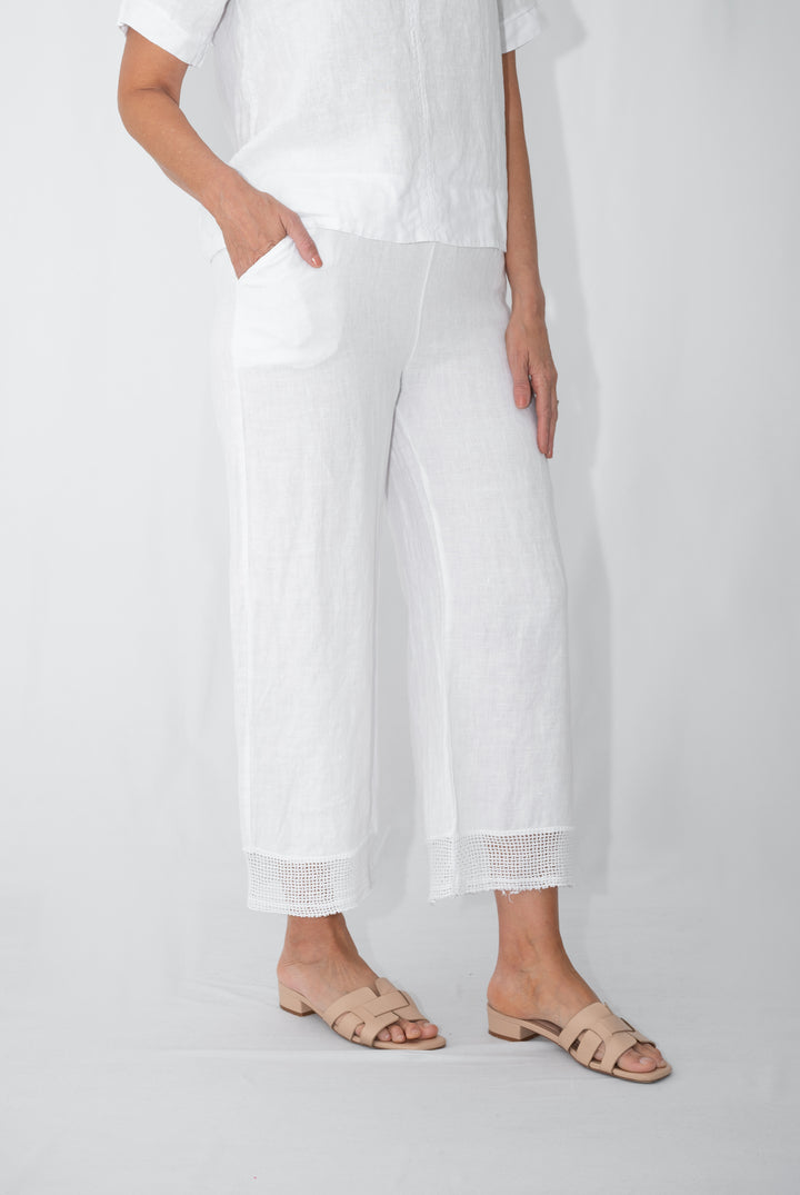 White linen pants styled with matching linen tank
Lightweight white linen pants for summer and travel